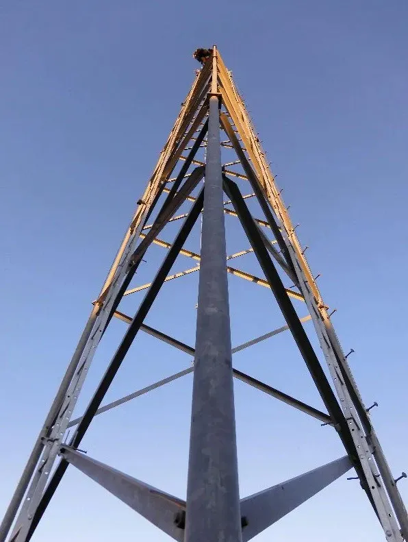 photo of climber at top of tower